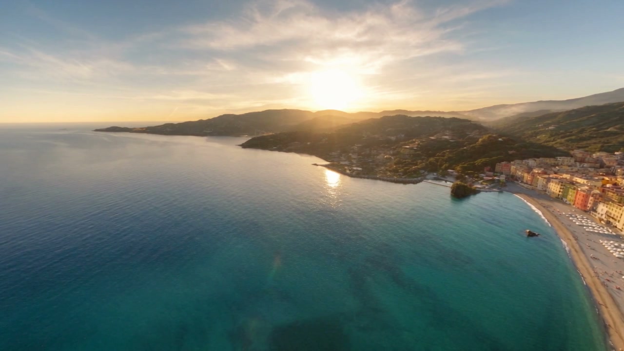The Gulf of Tigullio from above at dawn, the sun behind the Portofino headland